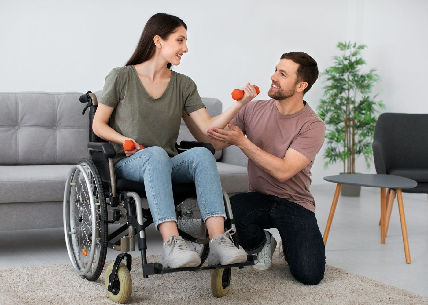 A support worker and wheelchair user sharing a smile during an exercise session